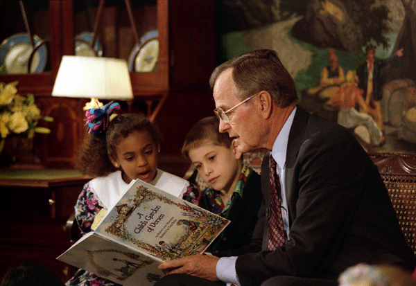 President George H. W. Bush reads to children