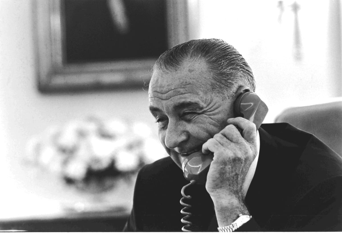 President Johnson having a good chuckle on the horn. 
