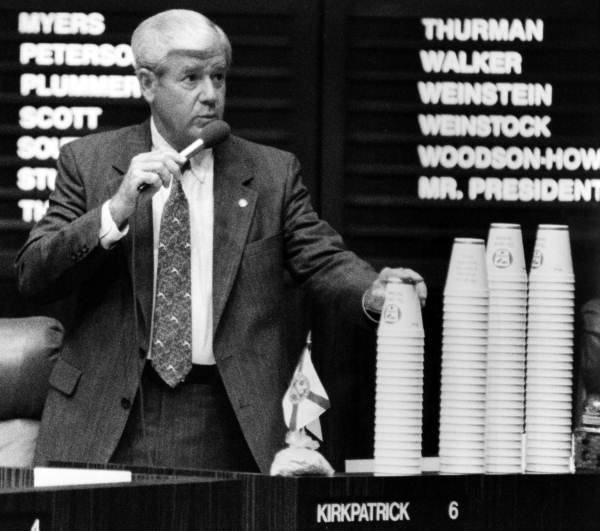 State Senator George Kirkpatrick with several stacks of coffee cups