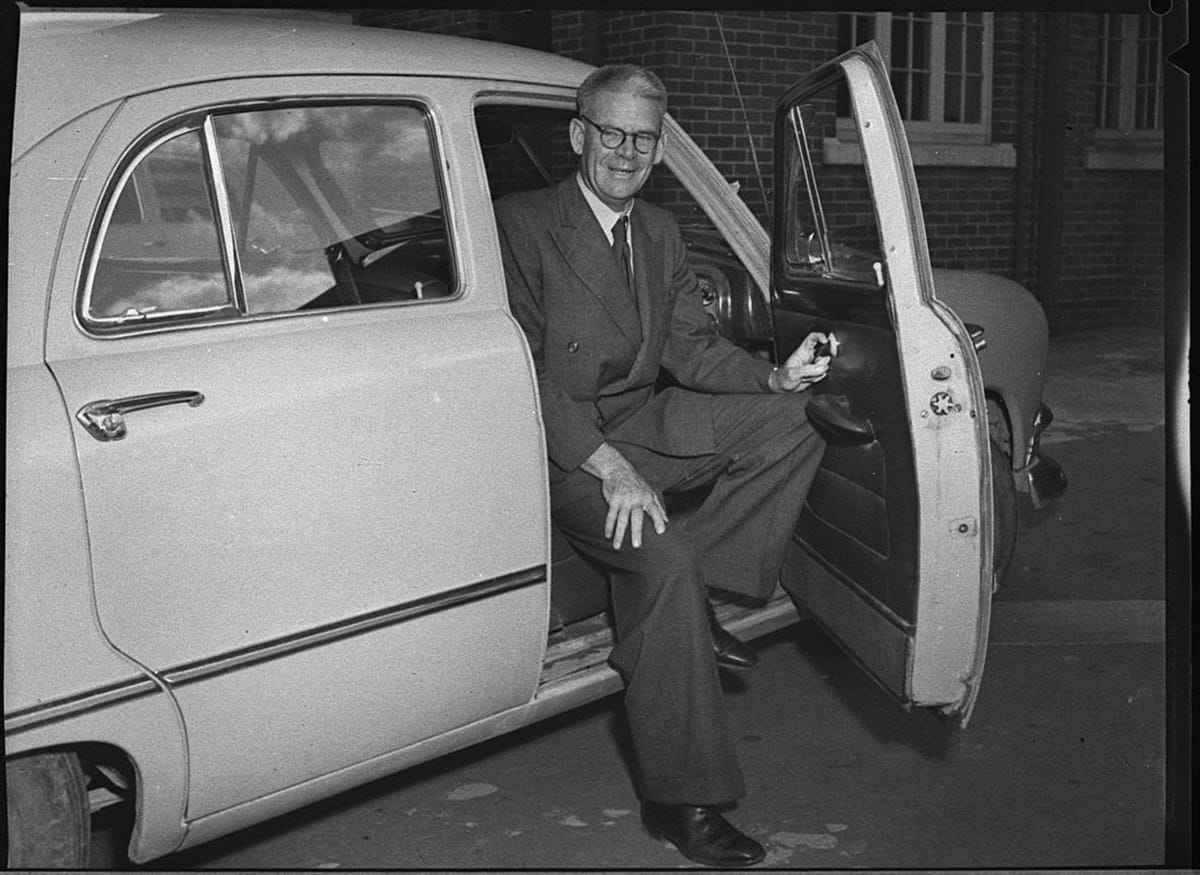 A man stepping out of a car on the last day of his services as President of the Hunter District Water Board.